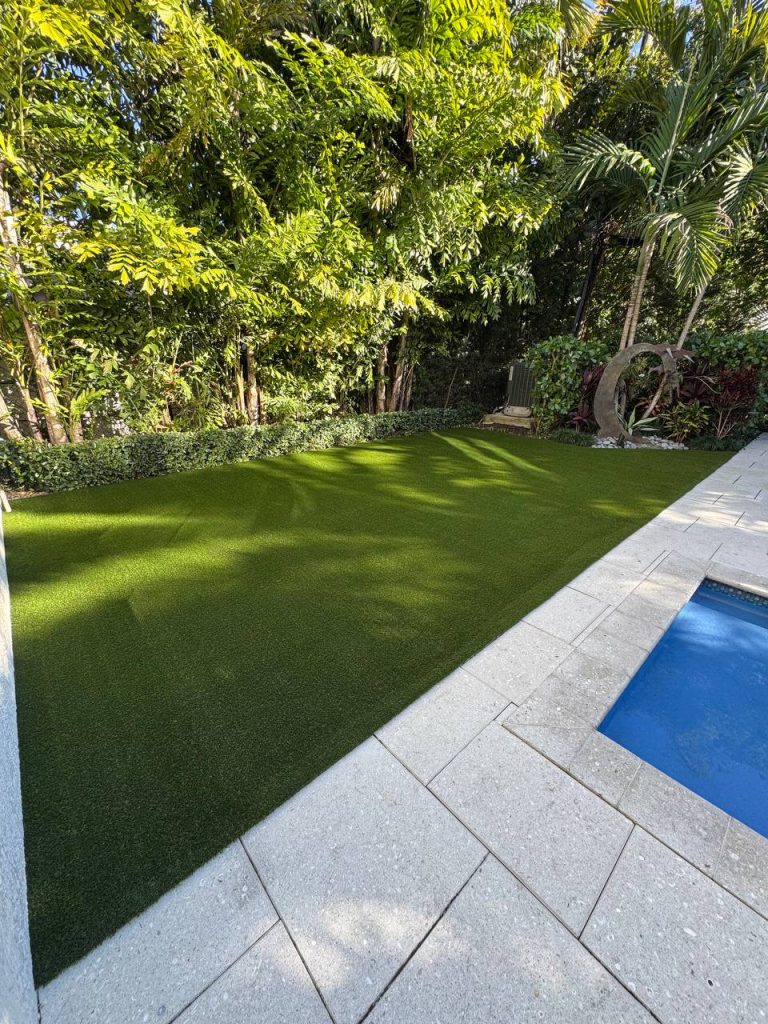 Turf beside a swimming pool.