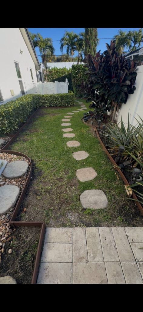 Earlier ground surface beside a hedge and screened patio.