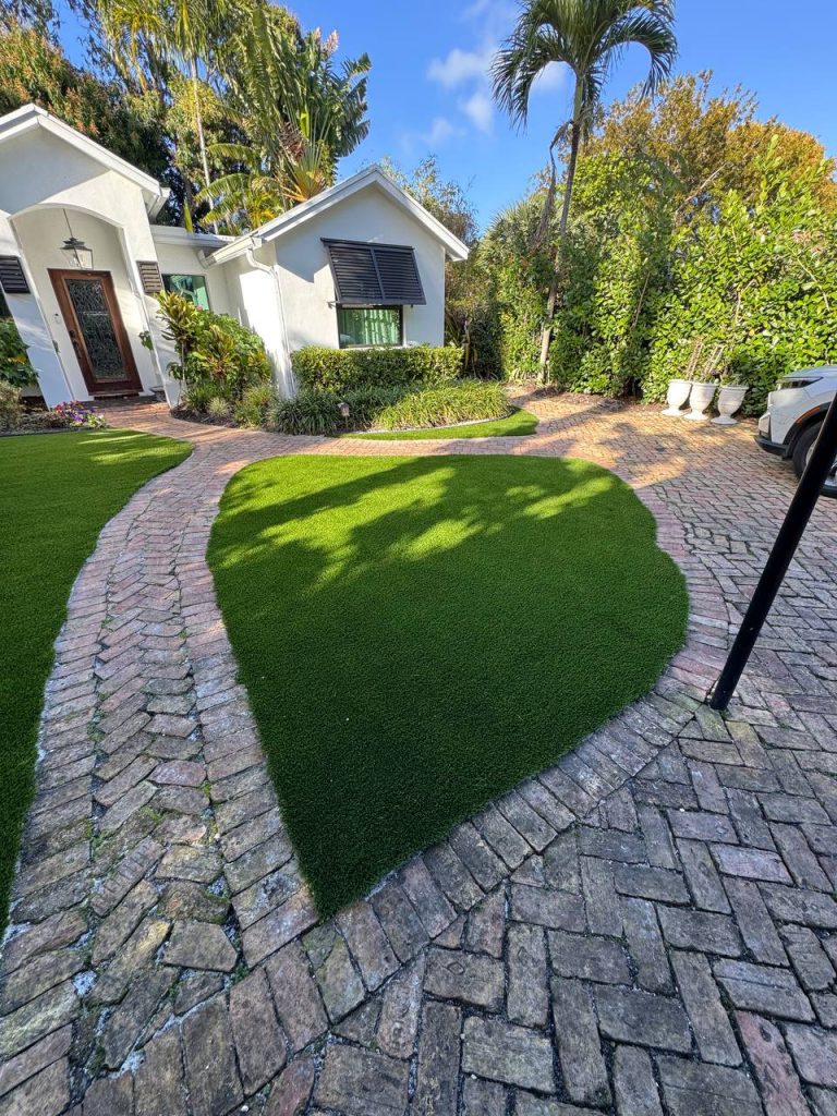 Turf around palms and curved brick paths.