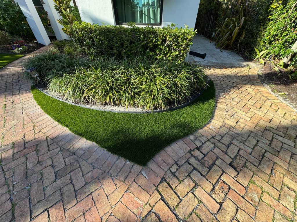 Turf around palms and curved brick paths.