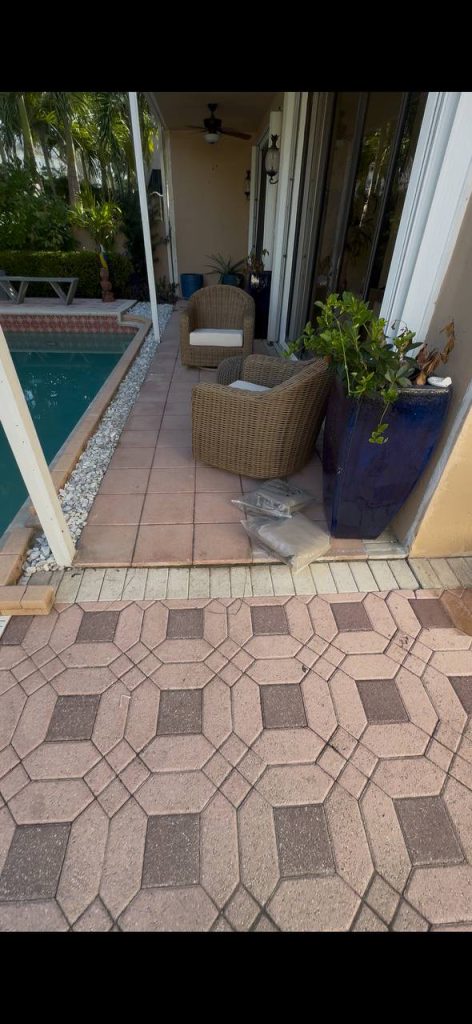 Earlier ground surface beside sliding doors and a covered swimming pool patio.